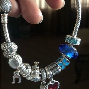 Pandora bracelet with 11 pieces. Excellent condition!!! Sparkly!!!! 9 in long